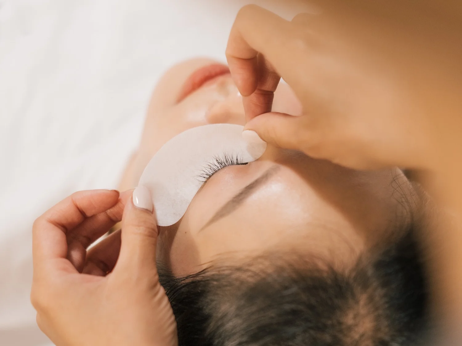 Lash extensions being applied at Liveo