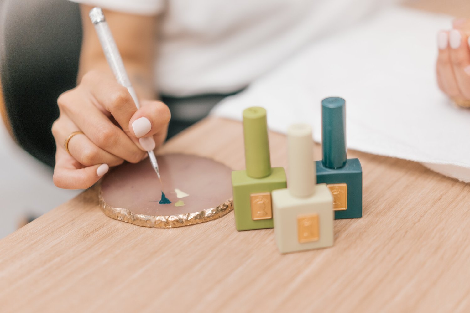 A Liveo nail artist mixing a custom gel colour